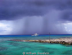 Rain... Reef Divers boat moored at Buccaneer Reef, Cayman... by William Goodwin 